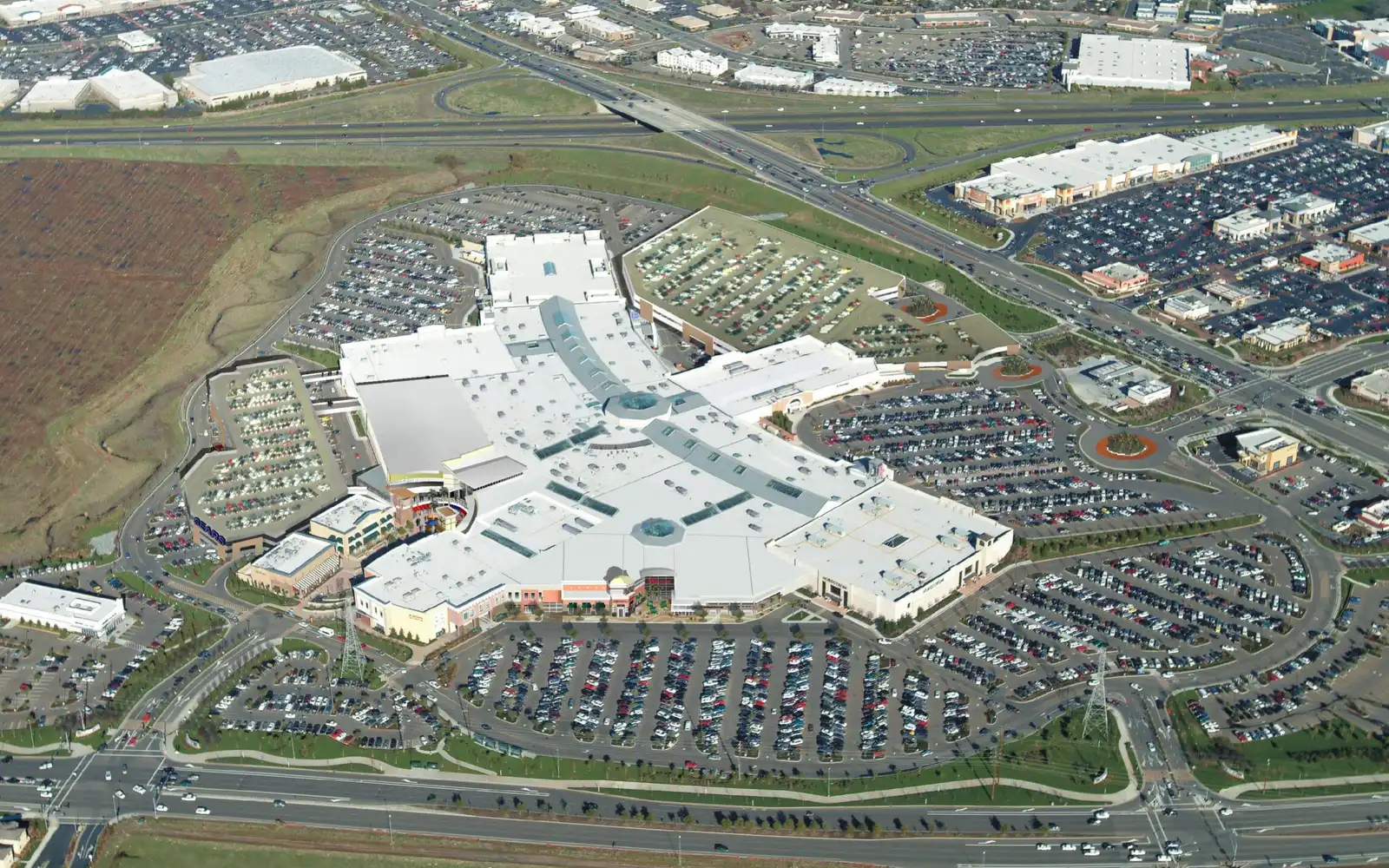 Aerial view of the Westfield Galleria mall in Roseville with its surrounding parking, neighboring retail buildings and the freeway